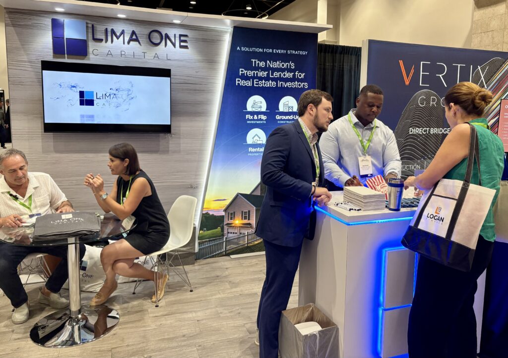 Lima One Capital at the FAMP Convention with Devin Stewart, Lorena Diaz, and Desmond Washington shown conversing. 