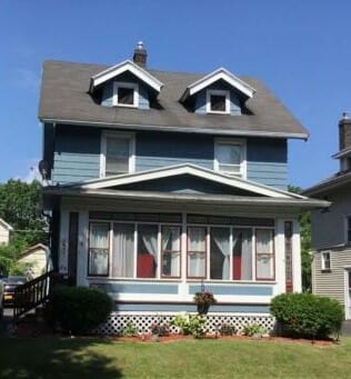 A two-story blue house with a gray roof and windows in Rochester, NY, highlighting Lima One Capital's Rental30 Premier® portfolio loan