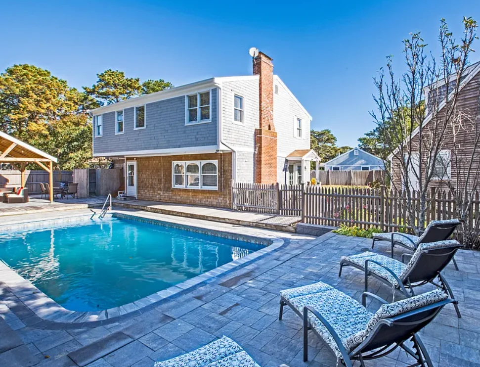 Exterior view of pool patio and rental property on Cape Cod in Massachusetts financed by Lima One.